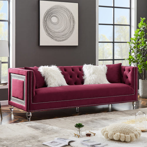 Three-seater red velvet sofa