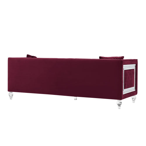 Three-seater red velvet sofa